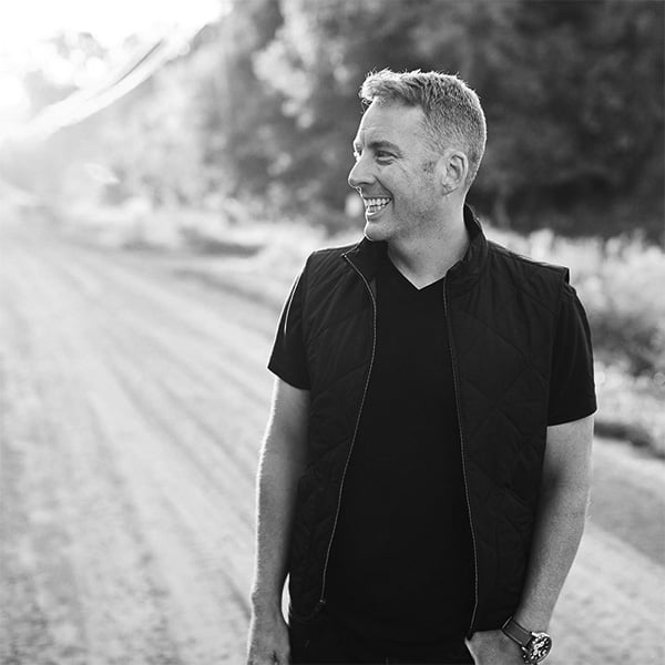 black and white  image of man on dirt road