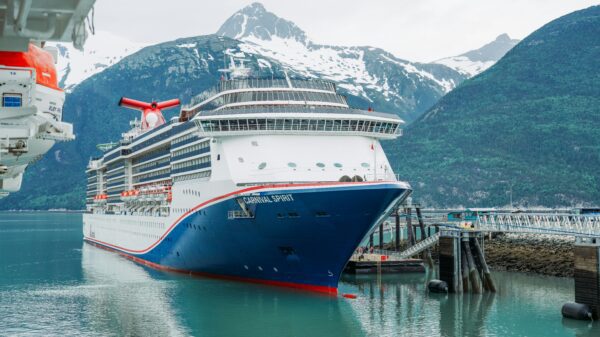 cruise ship in alaskan waters with mountain in background